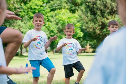 a group of young boys playing a game of frisbee