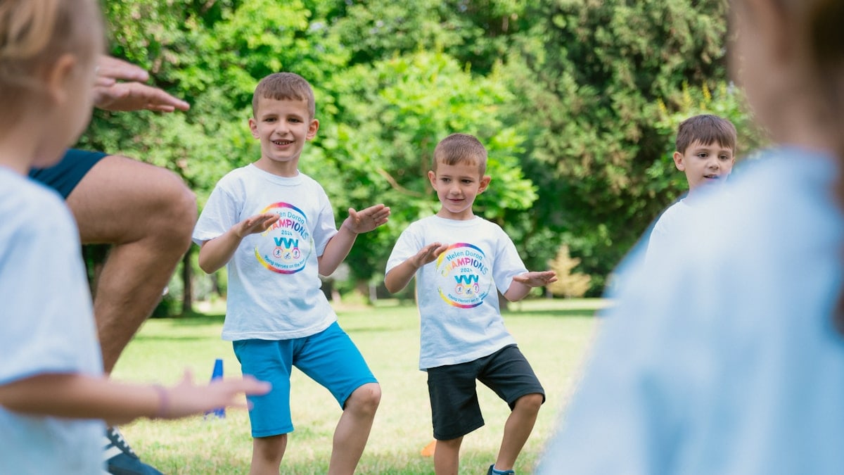 a group of young boys playing a game of frisbee